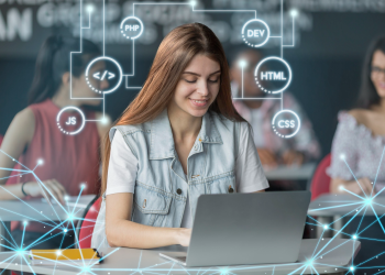 A long-haired woman using a laptop while coding
