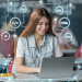 A long-haired woman using a laptop while coding