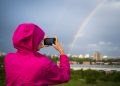 CARDIFF, UNITED KINGDOM - MAY 27: A woman photographs a rainbow over Cardiff City centre on May 27, 2019 in Cardiff, United Kingdom. (Photo by Matthew Horwood/Getty Images)