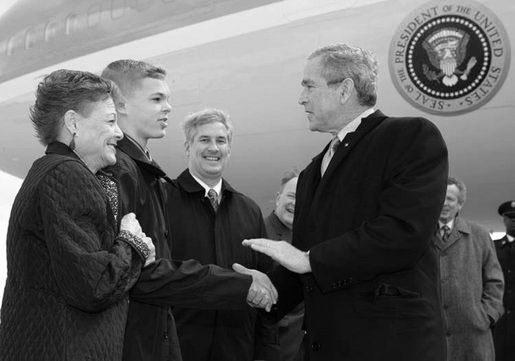 President George W. Bush greets Greece Athena High School senior, Jason McElwain and McElwain's mother, Debbie, upon arriving in Rochester, New York Tuesday, March 14, 2006. After serving as the team's manager McElwain, who is autistic, was called on to play during the team's last game of the season. McElwain became a local hero after he sank six 3-point shots during the last moments of his first ever varsity basketball game.  White House photo by Kimberlee Hewitt