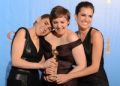 Lena Dunham (C) poses in the press room with her Best performance by an actress in a television comedy or musical series award for "Girls" with co-stars Zosia Mamet (L) and Allison Williams at the Golden Globes awards ceremony in Beverly Hills on January 13, 2013.    AFP PHOTO/Robyn BECK

 US-GOLDEN GLOBES-TROPHY