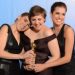 Lena Dunham (C) poses in the press room with her Best performance by an actress in a television comedy or musical series award for "Girls" with co-stars Zosia Mamet (L) and Allison Williams at the Golden Globes awards ceremony in Beverly Hills on January 13, 2013.    AFP PHOTO/Robyn BECK

 US-GOLDEN GLOBES-TROPHY