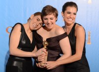 Lena Dunham (C) poses in the press room with her Best performance by an actress in a television comedy or musical series award for "Girls" with co-stars Zosia Mamet (L) and Allison Williams at the Golden Globes awards ceremony in Beverly Hills on January 13, 2013.    AFP PHOTO/Robyn BECK

 US-GOLDEN GLOBES-TROPHY