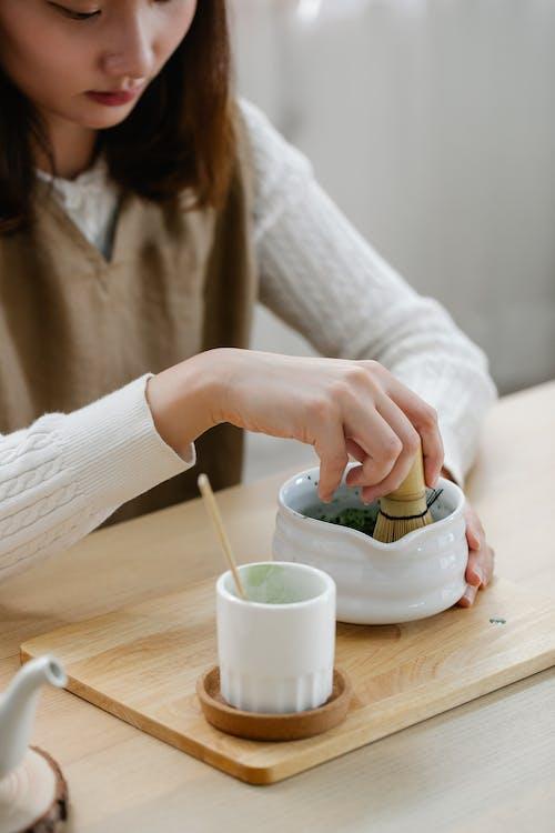 Free Woman in White Knit Sweater Holding White Ceramic Bowl Stock Photo