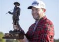 Branden Grace, of South Africa, holds the RBC Championship trophy after winning the final round of the RBC Heritage golf tournament in Hilton Head Island, S.C., Sunday, April 17, 2016. (AP Photo/Stephen B. Morton)
