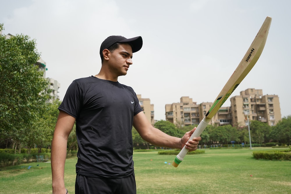 Tiger wearing a green cricket jersey aggressive pose with a cricket bat in  hand. Stock Illustration | Adobe Stock