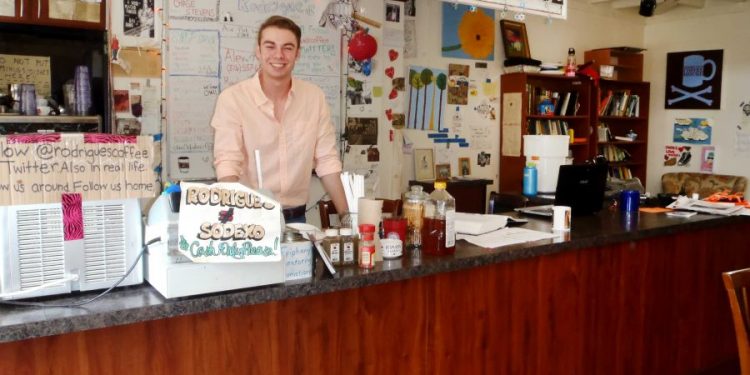 Irene Kate Patron/The Fordham Ram Phil Feinbusch tends the Rodrigue’s coffee couter as one of a dozen baristas who keep Rodrigue’s going.