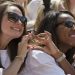 The University of Alabama Phi Mu's newest sorority members, Anna Misemer, left, and Marissa Lee, right, make their hand symbol during sorority Bid Day on Saturday, Aug. 16, 2014, in Tuscaloosa, Ala. The university became embroiled in controversy in 2013 after the student newspaper reported some white sororities had rejected blacks as new members because of race. At the end of 2014 sorority recruitment, black women made up 1 percent of new members. (AP Photo/Brynn Anderson)