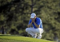Jordan Spieth pauses on the 18th green before putting out during the final round of the Masters golf tournament Sunday, April 10, 2016, in Augusta, Ga. (AP Photo/Chris Carlson)