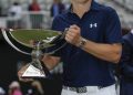 Jordan Spieth holds up the FedEX Cup trophy after winning the Tour Championship Golf Tournament at East Lake Golf Club Sunday, Sept. 27, 2015. (AP Photo/John Amis)